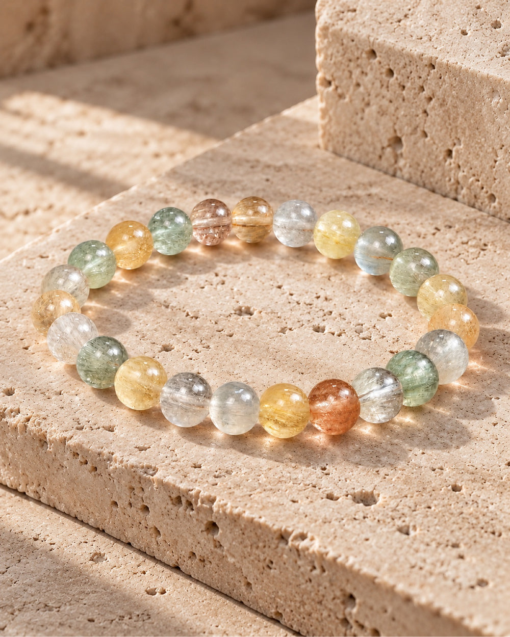 Multicolor rutilated quartz bracelet on travertine